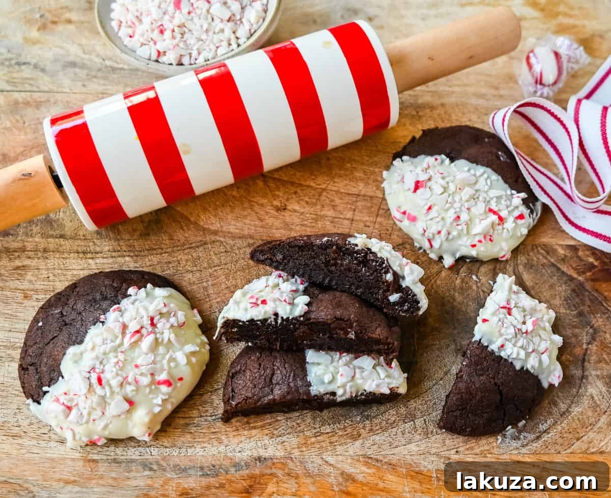 White Chocolate Dipped Peppermint Chocolate Cookies. The Double Chocolate Peppermint Cookies are soft baked, rich double chocolate brownie cookies dipped in white chocolate and covered with peppermint candy canes. The perfect Christmas holiday cookie recipe.