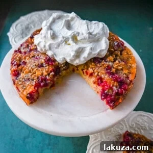 Nantucket Cranberry Pie, a moist almond cake dessert with tart cranberries and nuts, perfect for holiday gatherings.