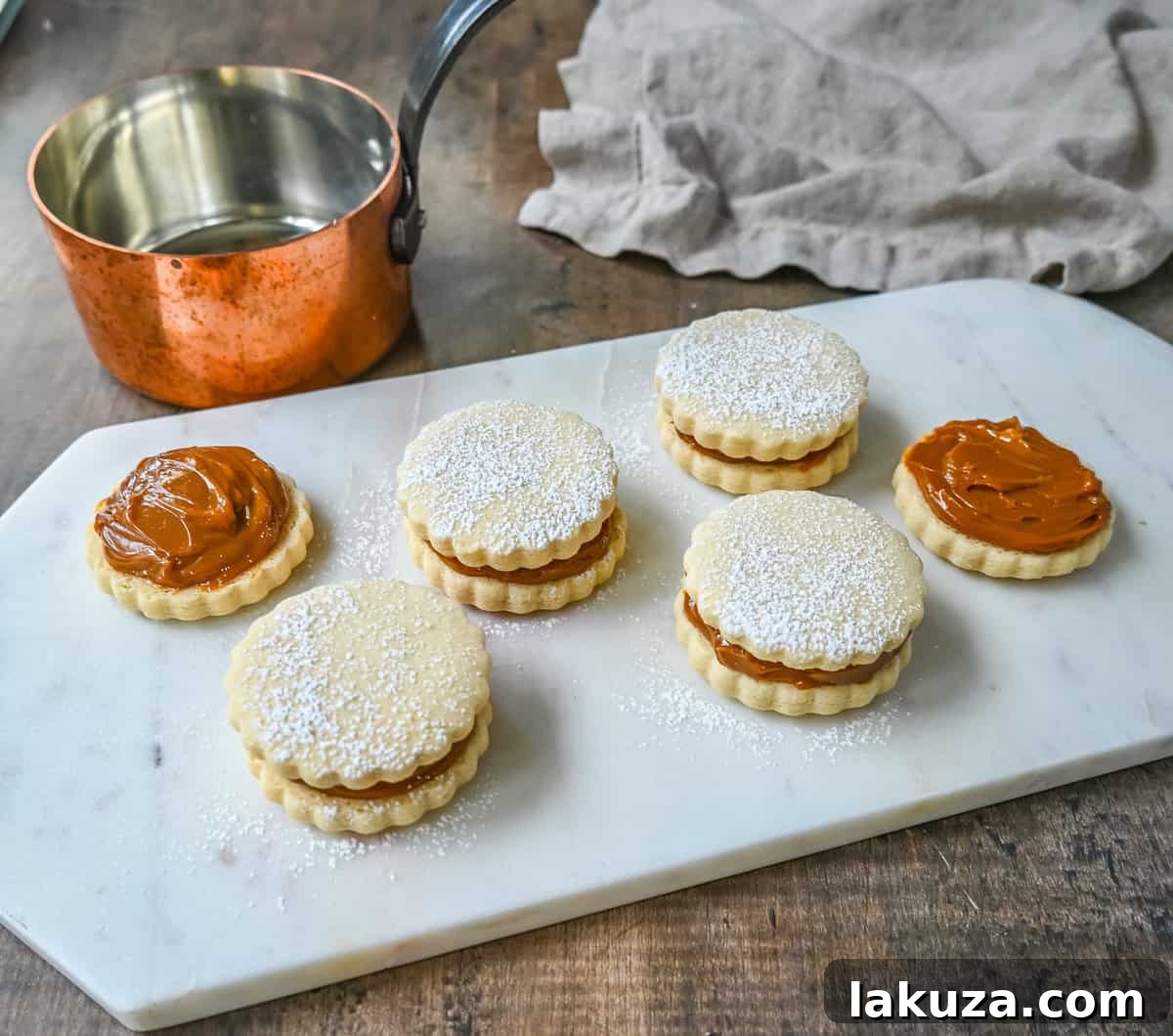 Alfajores with half coconut, half powdered sugar coating.