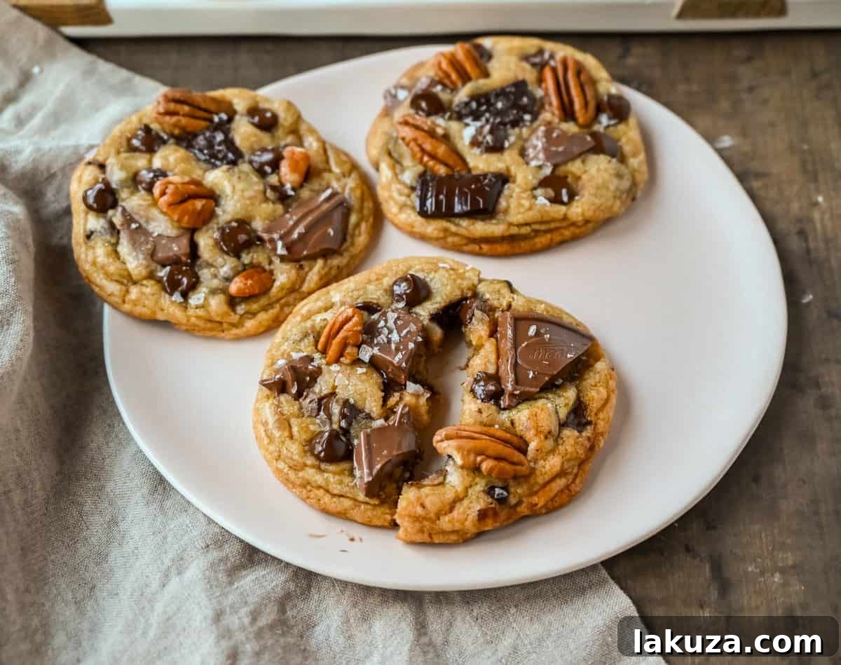 Golden Brown Butter Pecan Chocolate Chunk Delights 4 A bowl of rich cookie dough generously studded with chocolate chunks and pecans, ready for baking.