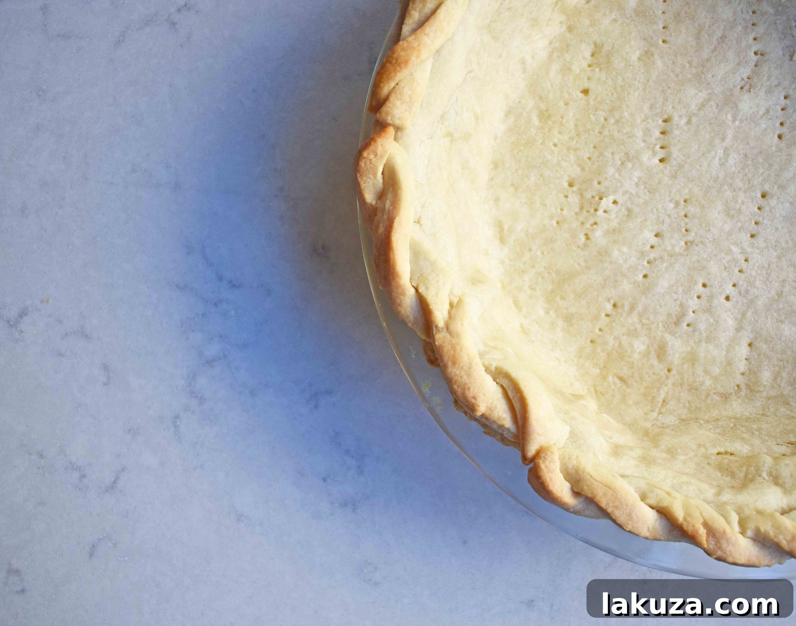 Close-up of a golden, flaky pie crust cooling on a wire rack
