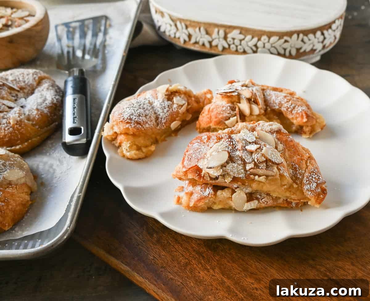 Interior view of a sliced almond croissant, revealing the moist, sweet almond filling nestled within its flaky layers.