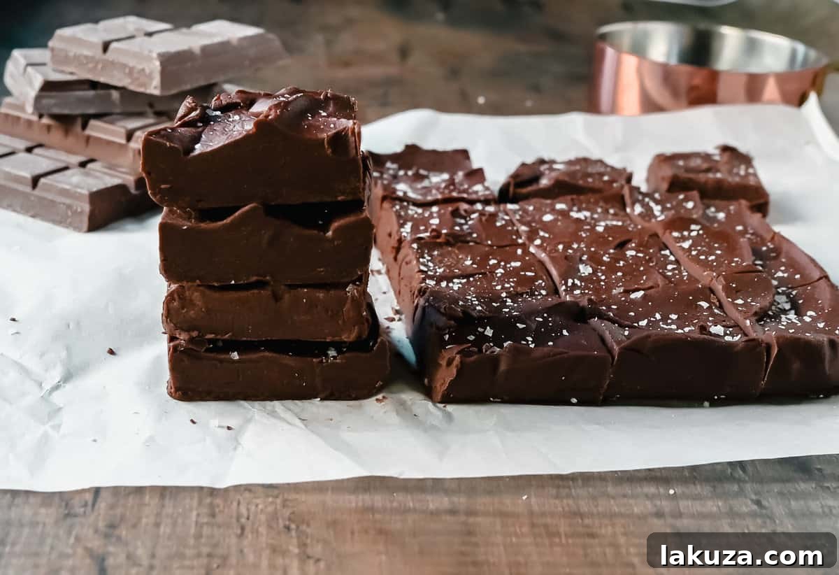 Close-up of freshly made Easy 2-Ingredient Microwave Chocolate Fudge, showcasing its rich, smooth texture. A perfect quick dessert or gift.