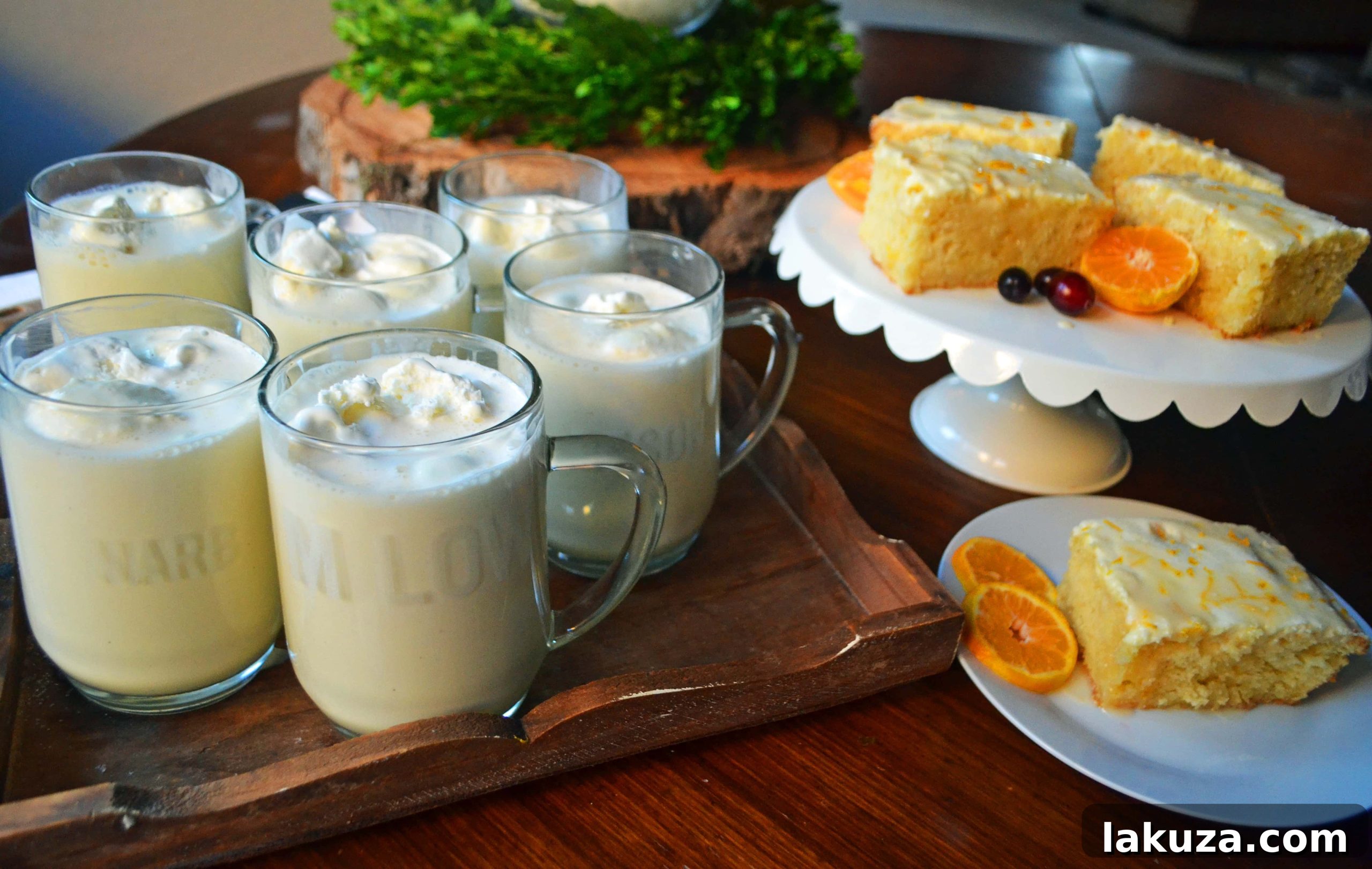 A festive setting with Orange Roll Breakfast Cake, cups of eggnog, and holiday decorations, highlighting a cozy Christmas morning.