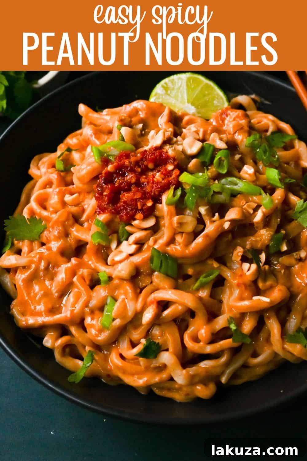 Creamy Chili Peanut Noodles 6 A top-down view of a large bowl of Spicy Peanut Noodles, generously garnished with cilantro, green onions, and chopped peanuts, ready for serving.