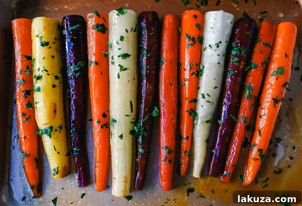 Sheet pan with honey glazed carrots baking in the oven