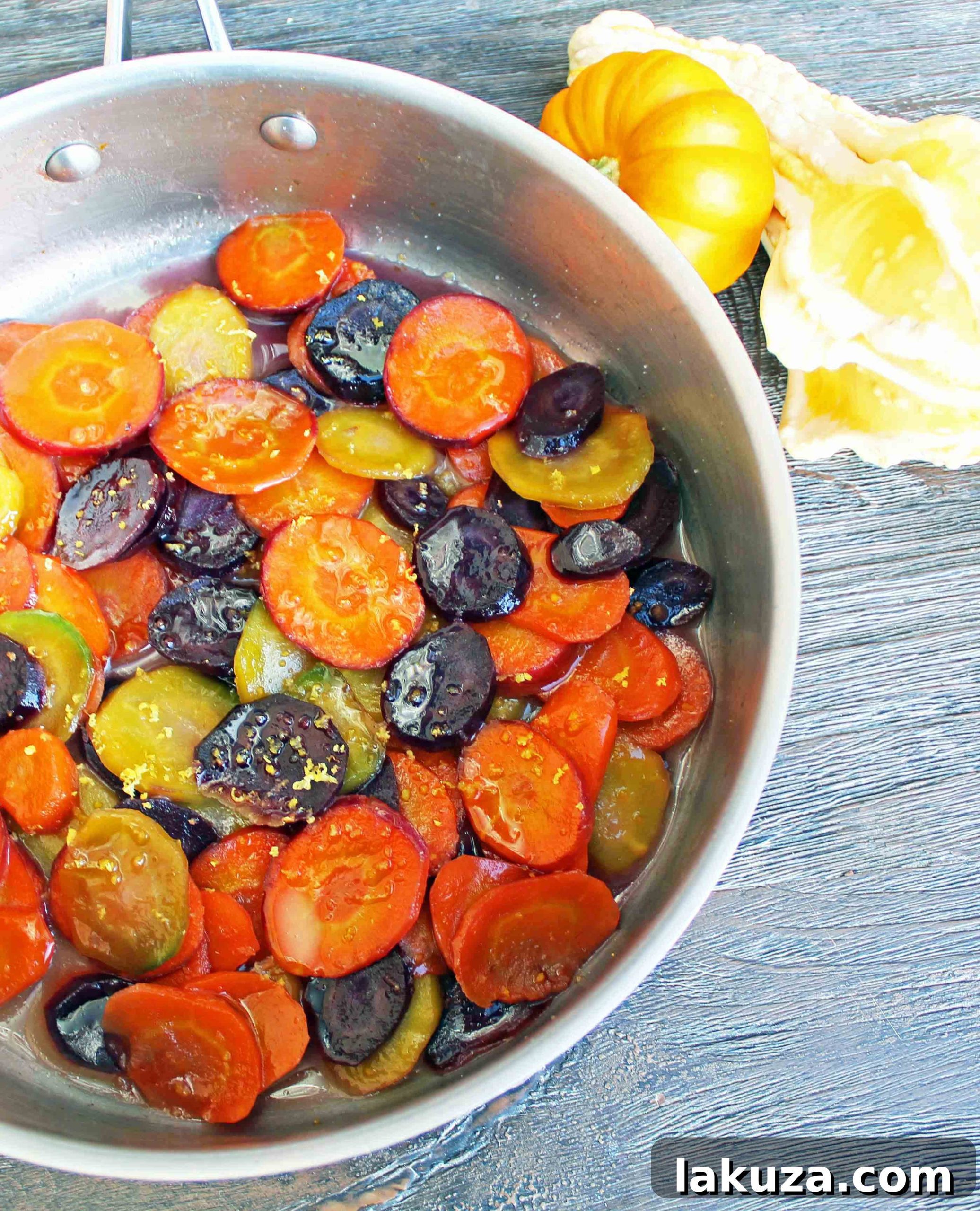 An array of colorful heirloom carrots at a farmers market stall