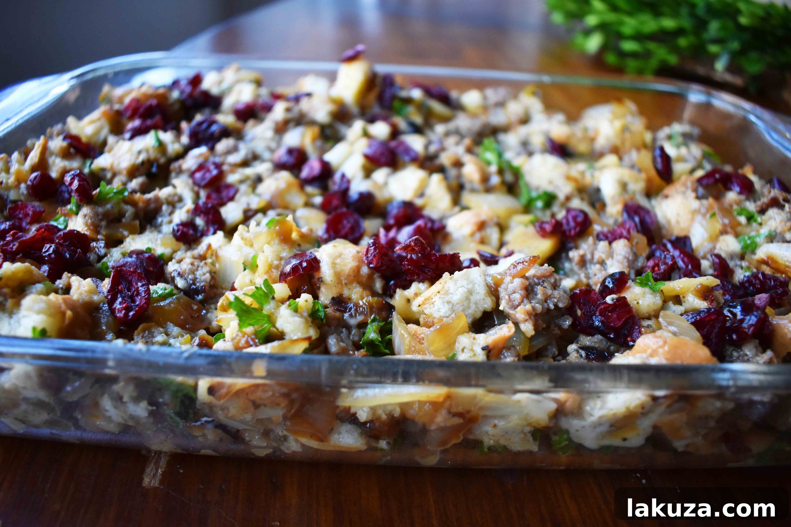 Detailed close-up of the Cranberry Apple Sausage Stuffing mixture before baking, showing diced bread, sausage, and other ingredients.