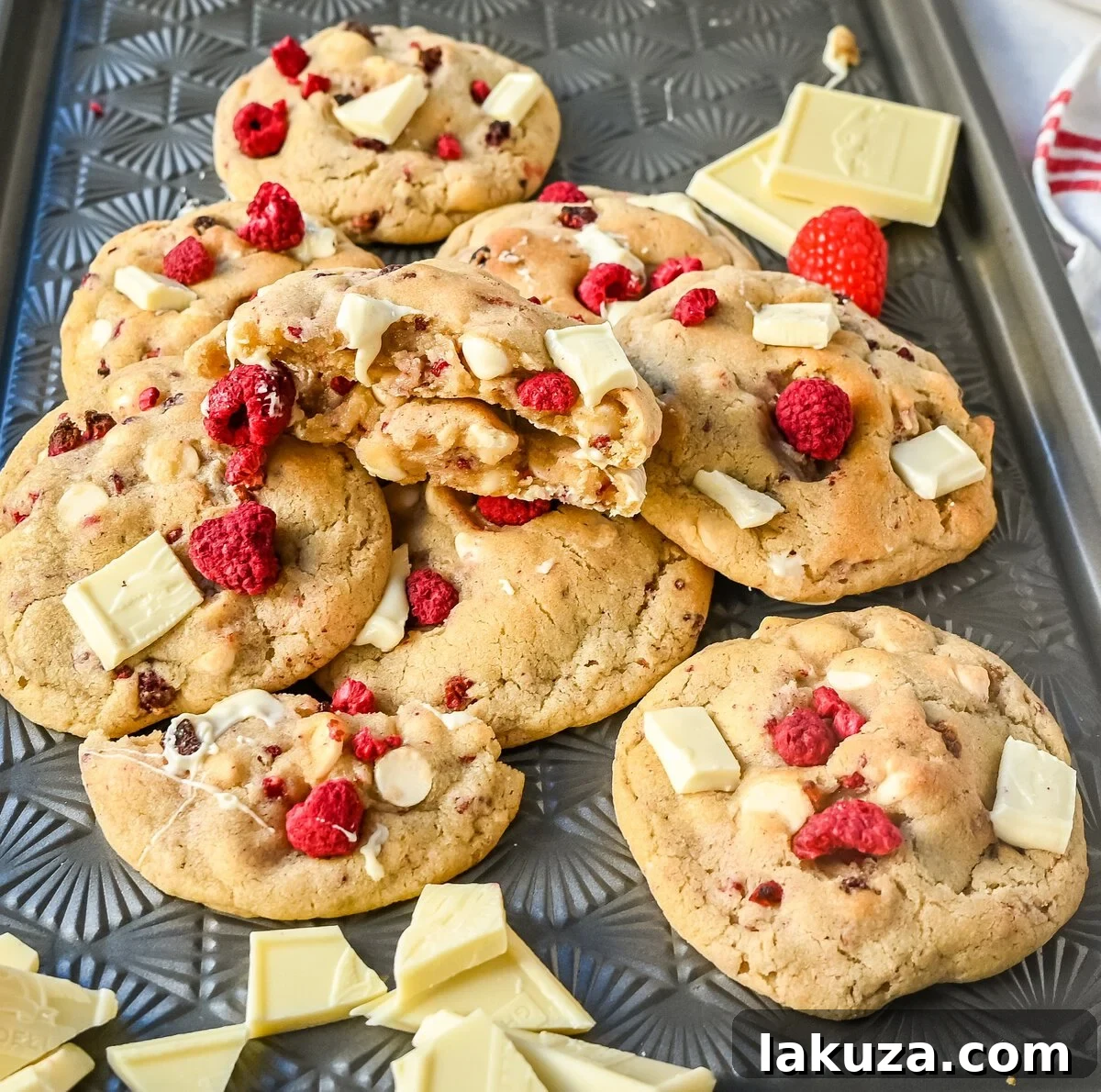 A bowl of white chocolate chips and chunks, ready for baking delicious white chocolate raspberry cookies.