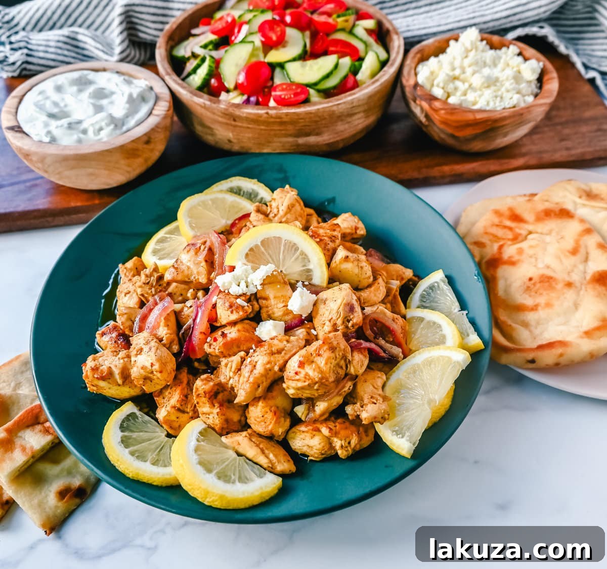 Close-up of perfectly cooked chicken shawarma with red onions on a baking sheet.