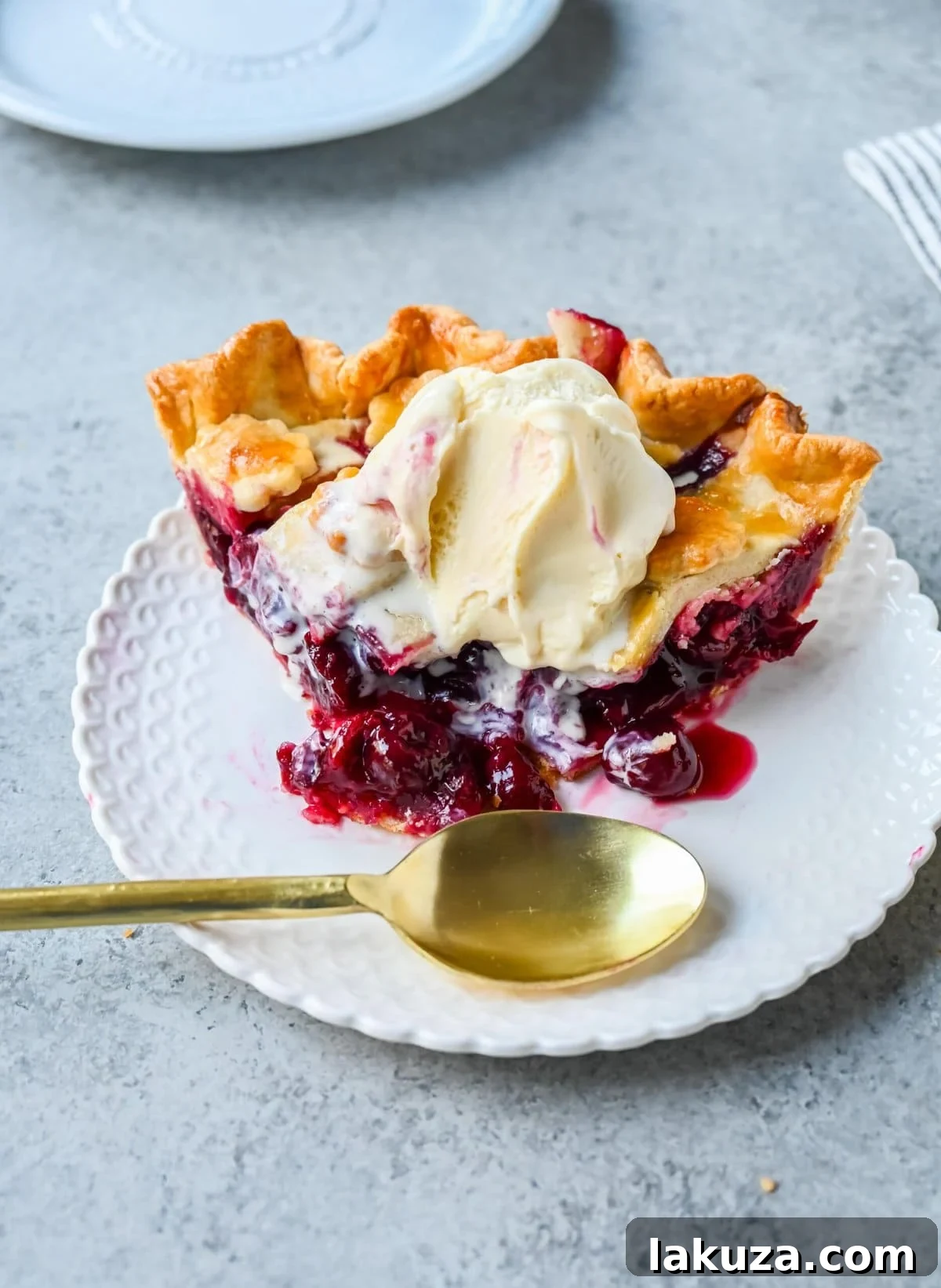 Homemade cherry pie is bursting with sweet-tart cherries nestled in a flaky, golden crust and topped with vanilla bean ice cream. I am sharing tips and tricks for making sweet cherry pie at home.