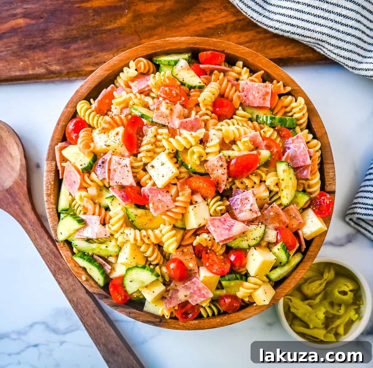 Easy Pasta Salad served in a large bowl, garnished with fresh herbs, showcasing the rich colors and textures of the ingredients.