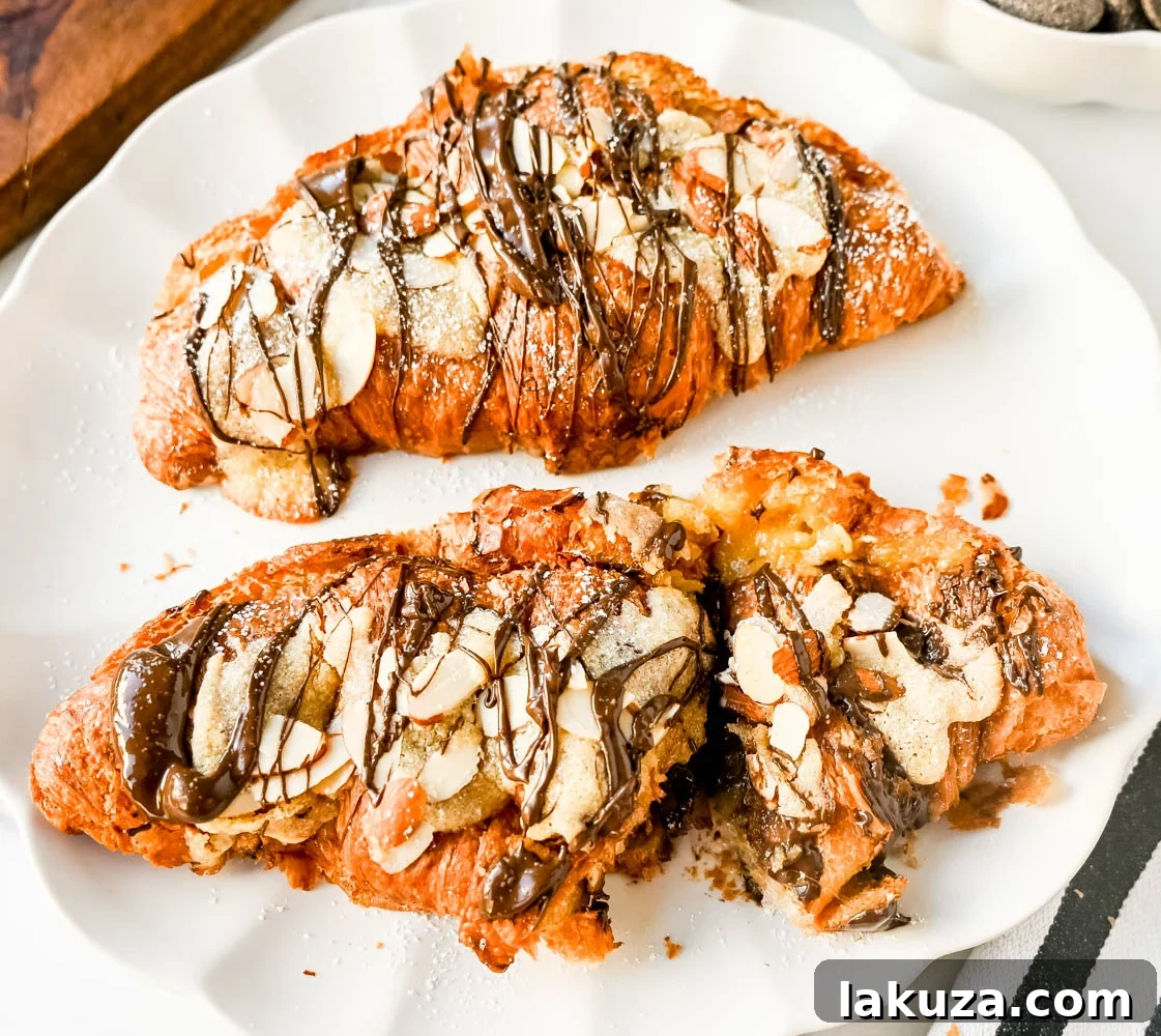 Irresistible Chocolate Almond Croissants 3 Close-up of baked chocolate almond croissants on a cooling rack, showcasing the rich filling.