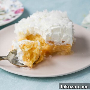 This Coconut Poke Cake is made with a baked cake mix and filled with cream of coconut and sweetened condensed milk and topped with sweet whipped cream and coconut. This Coconut Tres Leches Cake is so easy to make and is perfect for potlucks and parties.