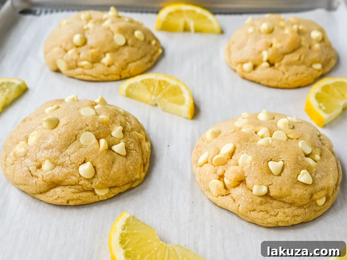 Close-up of a stack of golden-baked Levain Bakery Lemon Cookies, highlighting their rich, thick structure and soft interior.