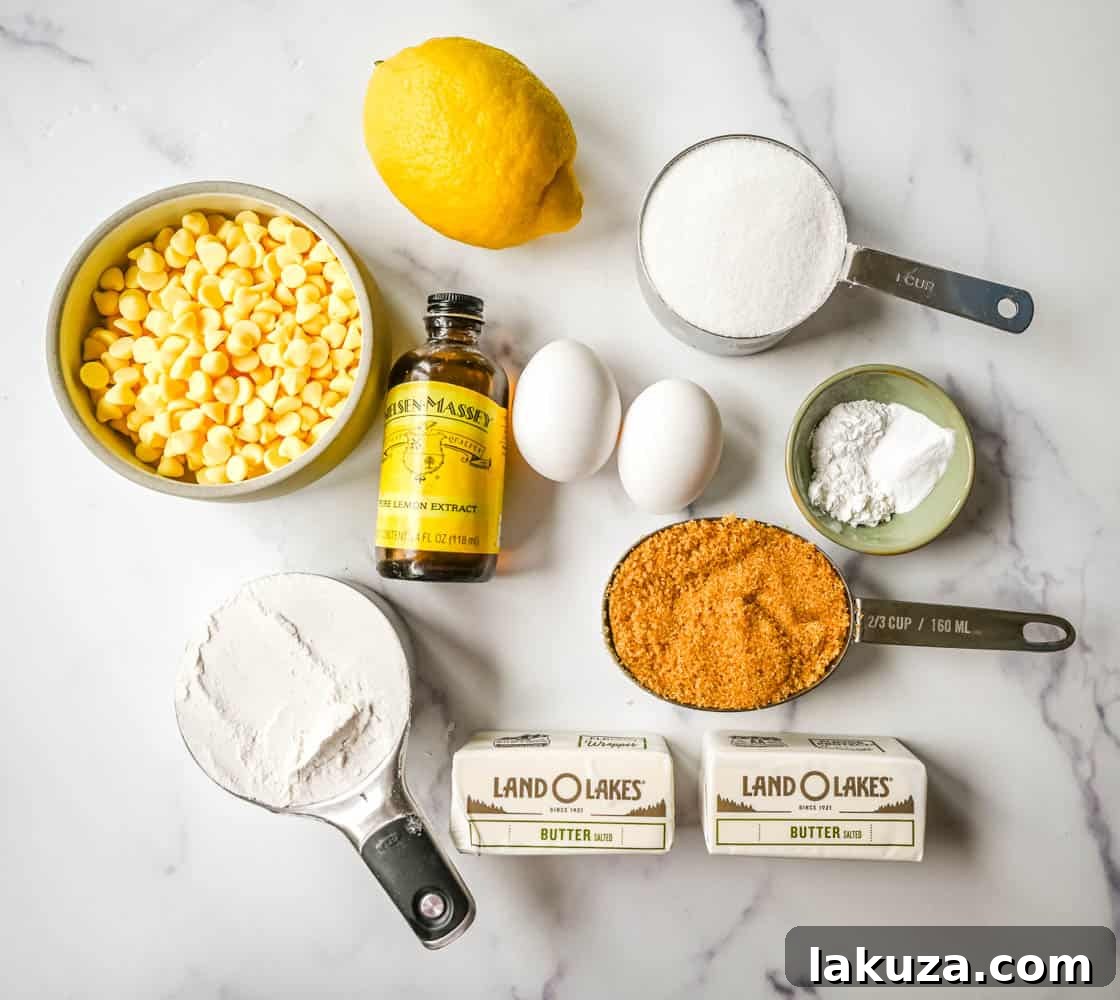 A collection of key ingredients for making Levain Bakery Lemon Cookies, including fresh lemons, butter, flour, and a bowl of lemon chips.