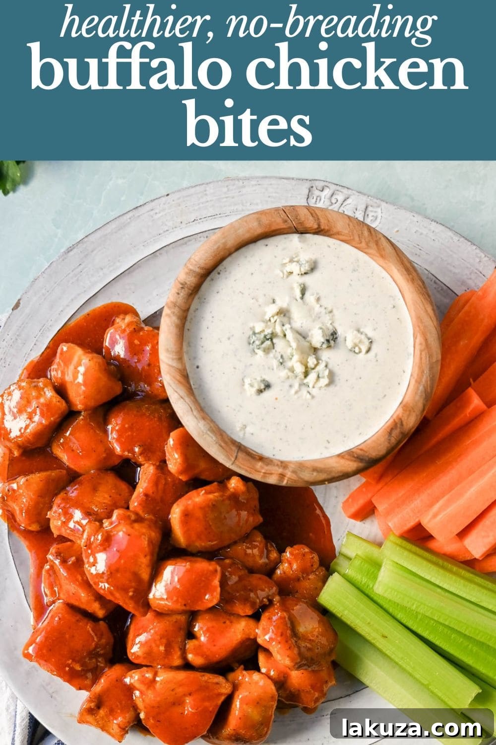 A vibrant platter of Buffalo Chicken Bites, garnished with fresh herbs and served with ranch dressing and celery sticks, highlighting the healthy and delicious aspect.