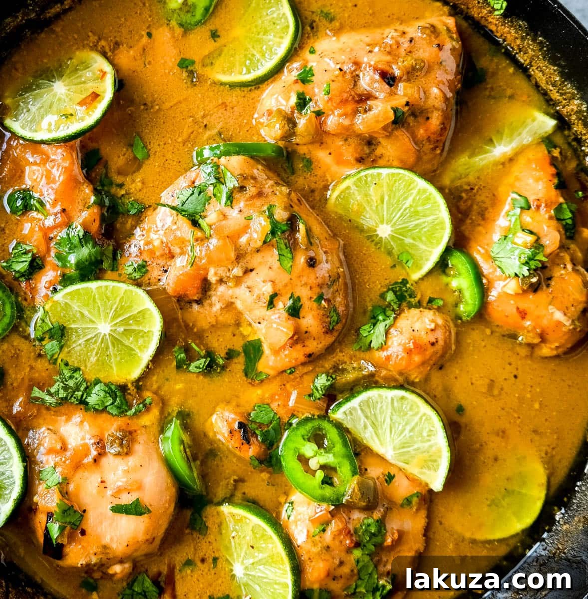 Island Zest Coconut Lime Chicken 3 Skillet Coconut Lime Chicken with a vibrant green garnish, ready to be served.