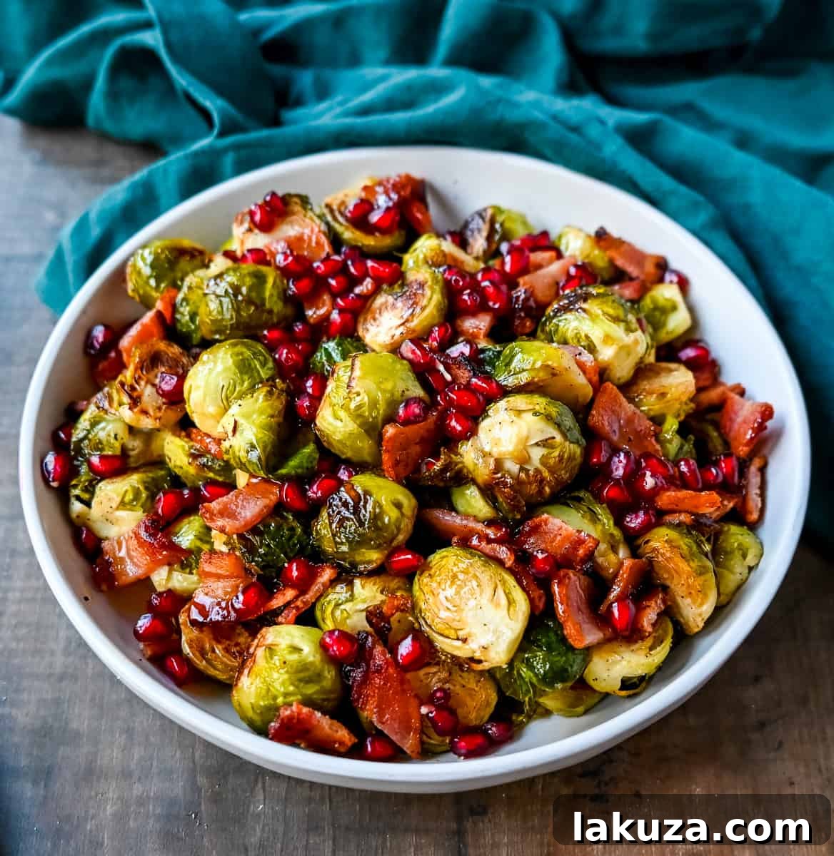 Smoky Bacon and Caramelized Brussels Sprouts 3 Perfectly roasted Brussels sprouts garnished with crisp bacon, sweet maple syrup, and fresh pomegranate seeds for a holiday meal.