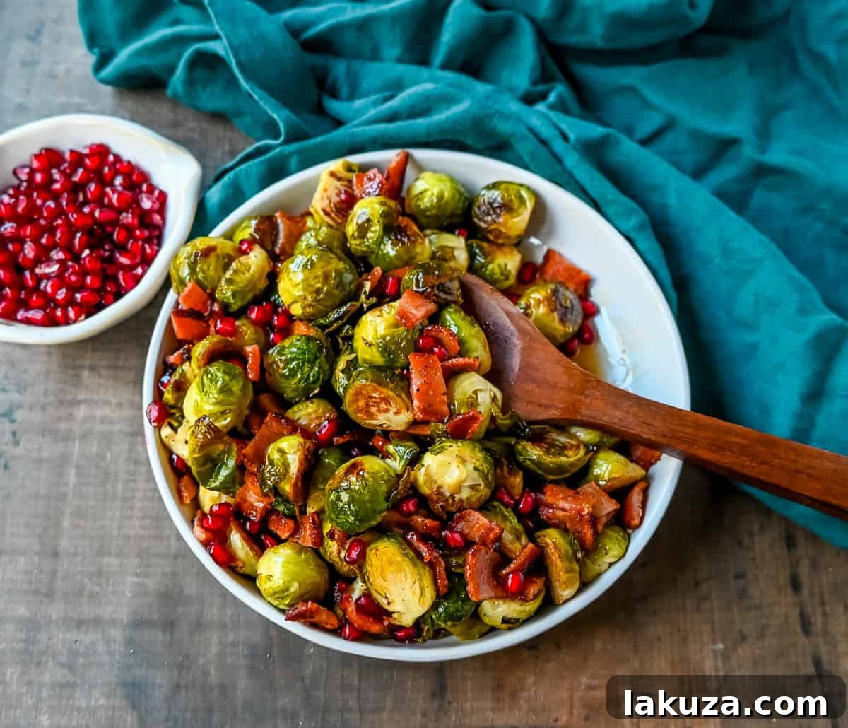 Smoky Bacon and Caramelized Brussels Sprouts 7 A vibrant platter of roasted Brussels sprouts, bacon, maple syrup, and pomegranates, ready to be served.