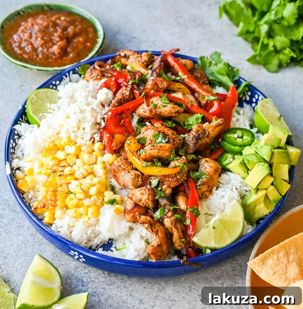 Sizzling Chicken Fajita Bowl 3 Customizable Chicken Fajita Bowl with vibrant ingredients including seasoned chicken, colorful peppers, and fresh garnishes, ideal for healthy eating.