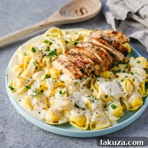 Tortellini Alfredo with Grilled Chicken is made with cheese tortellini tossed with parmesan cheese alfredo sauce and served with Italian grilled chicken. This Chicken Tortellini Alfredo Recipe is the ultimate comfort food.