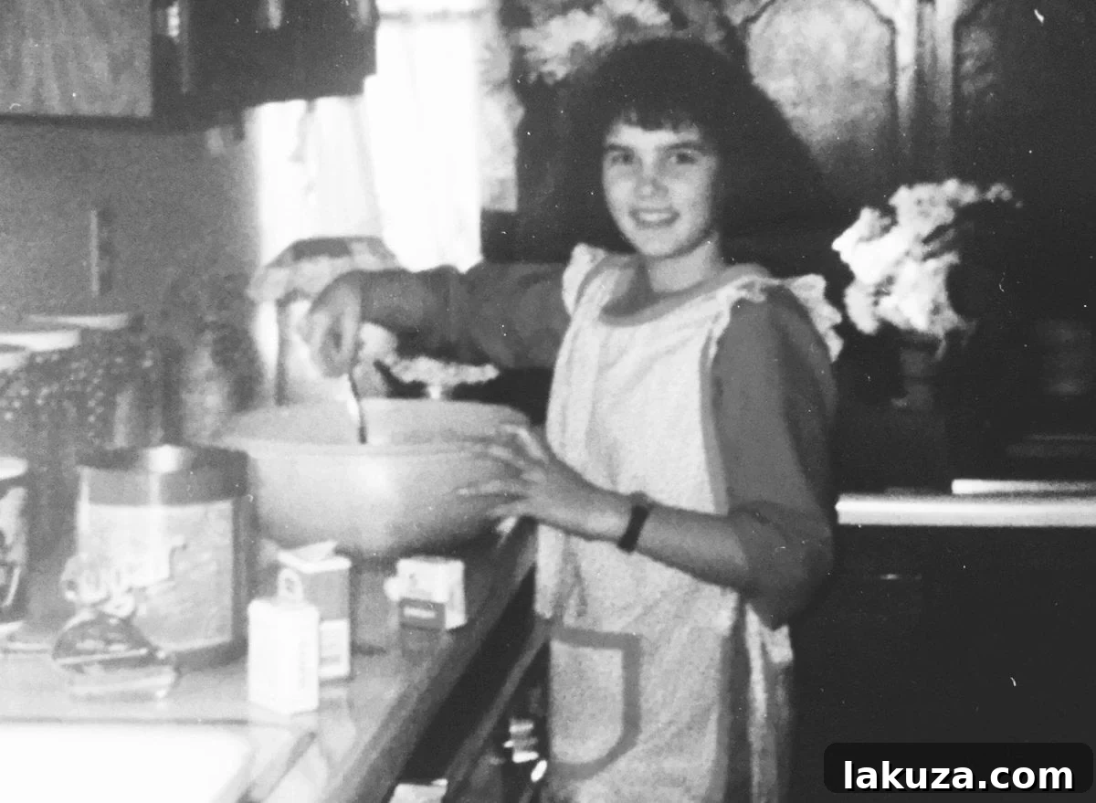 A classic 1980s family photo featuring a young girl with sky-high bangs and permed hair alongside her family, depicting a nostalgic moment.