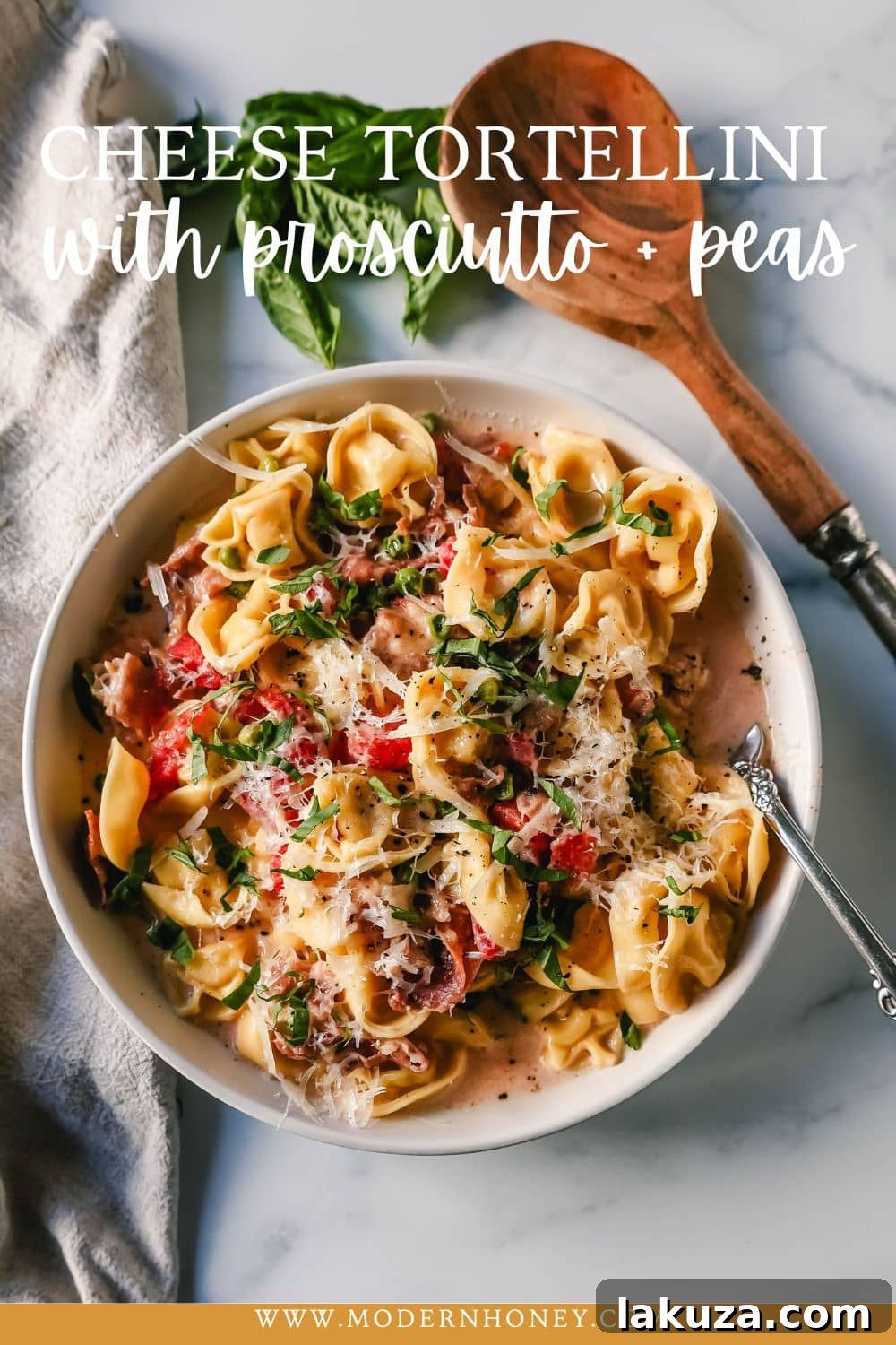 A beautifully plated dish of Creamy Tortellini with Prosciutto and Peas, garnished with fresh basil.
