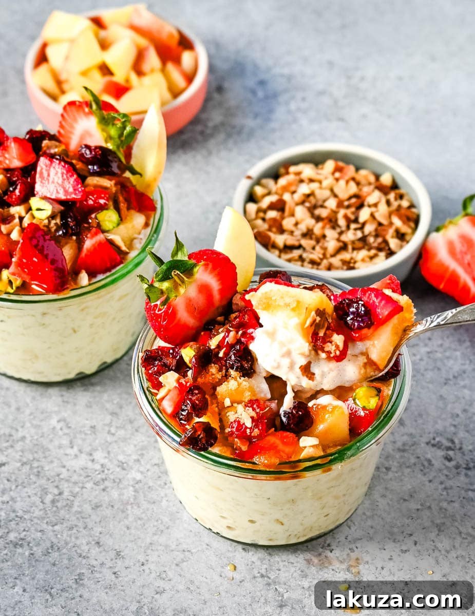 Dreamy Overnight Oats 5 A person topping Bircher Muesli Overnight Oats with fresh strawberries, blueberries, and a sprinkle of brown sugar.