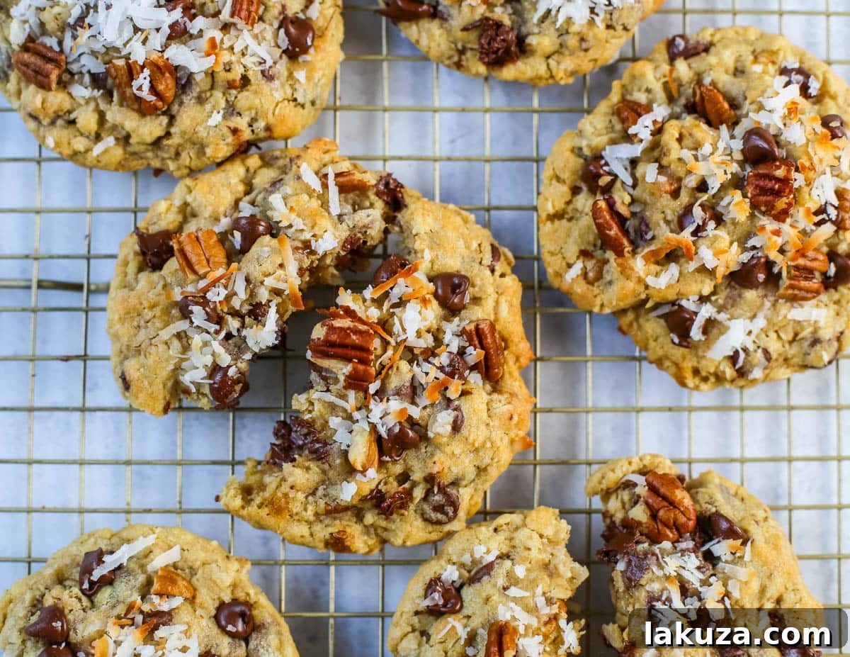 A close-up shot of the interior of a Cowboy Cookie, showcasing its rich mix of oats, chocolate, coconut, and pecans.