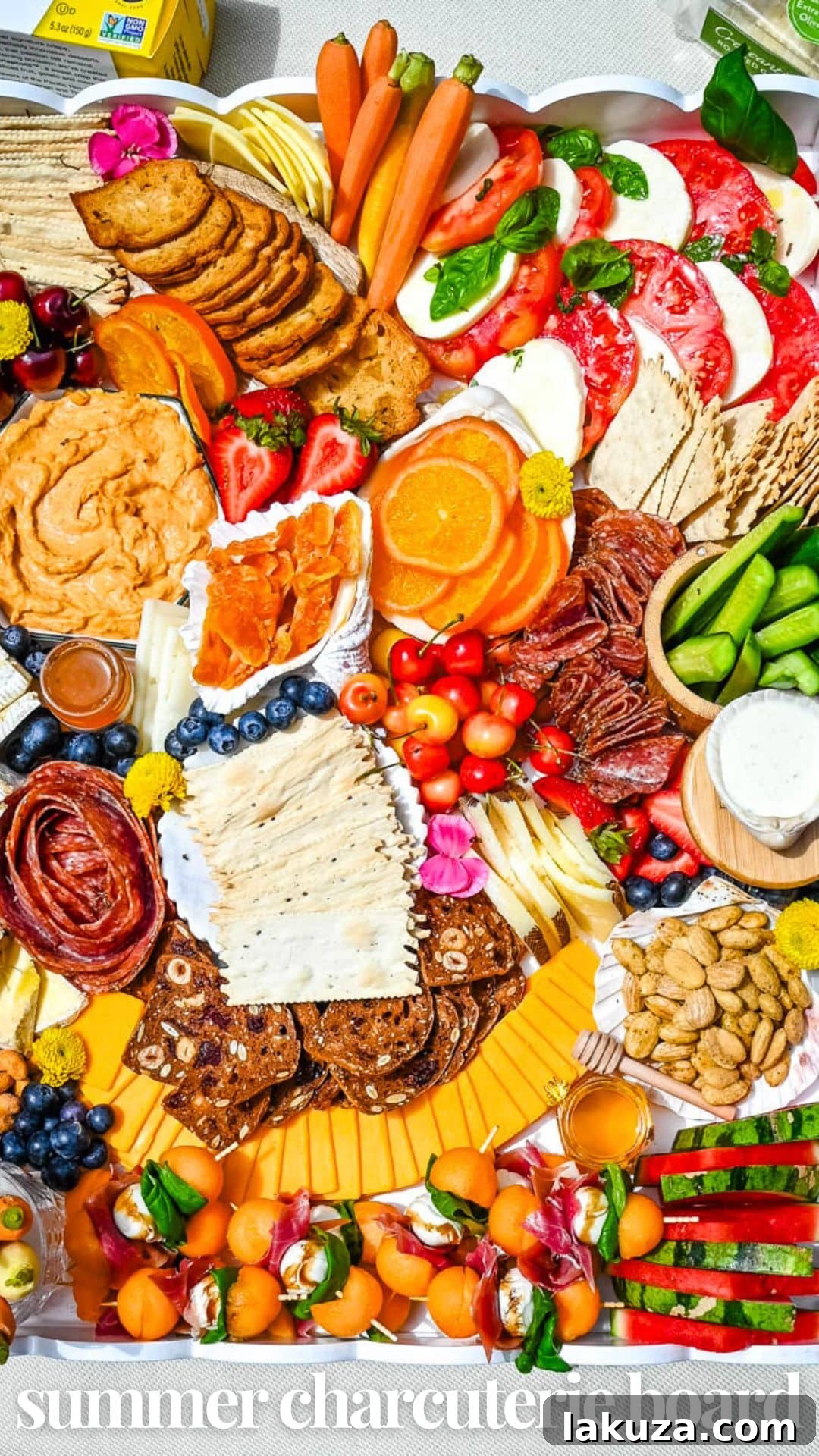 A stunning full overhead shot of an epic summer charcuterie board, ready to be enjoyed.