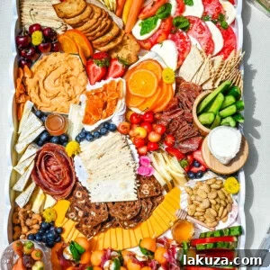 Summer Charcuterie Board with fresh fruits, cheeses, and meats.