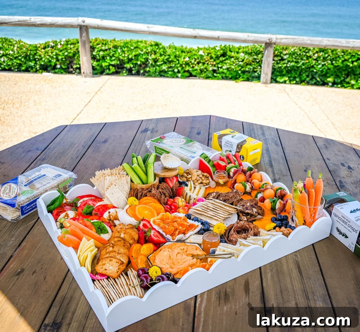 Close-up of a vibrant summer charcuterie board featuring a colorful array of fresh berries, melon, and greens.