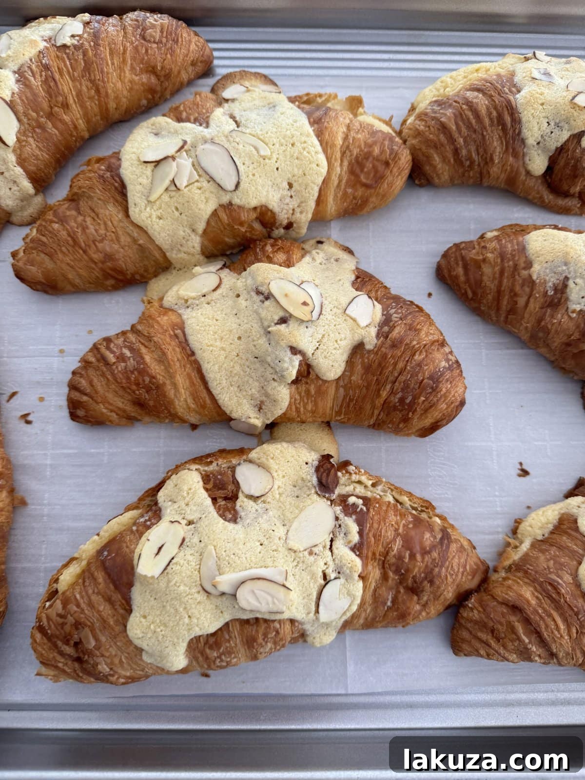 Homemade almond croissants cooling on a rack, ready to be served
