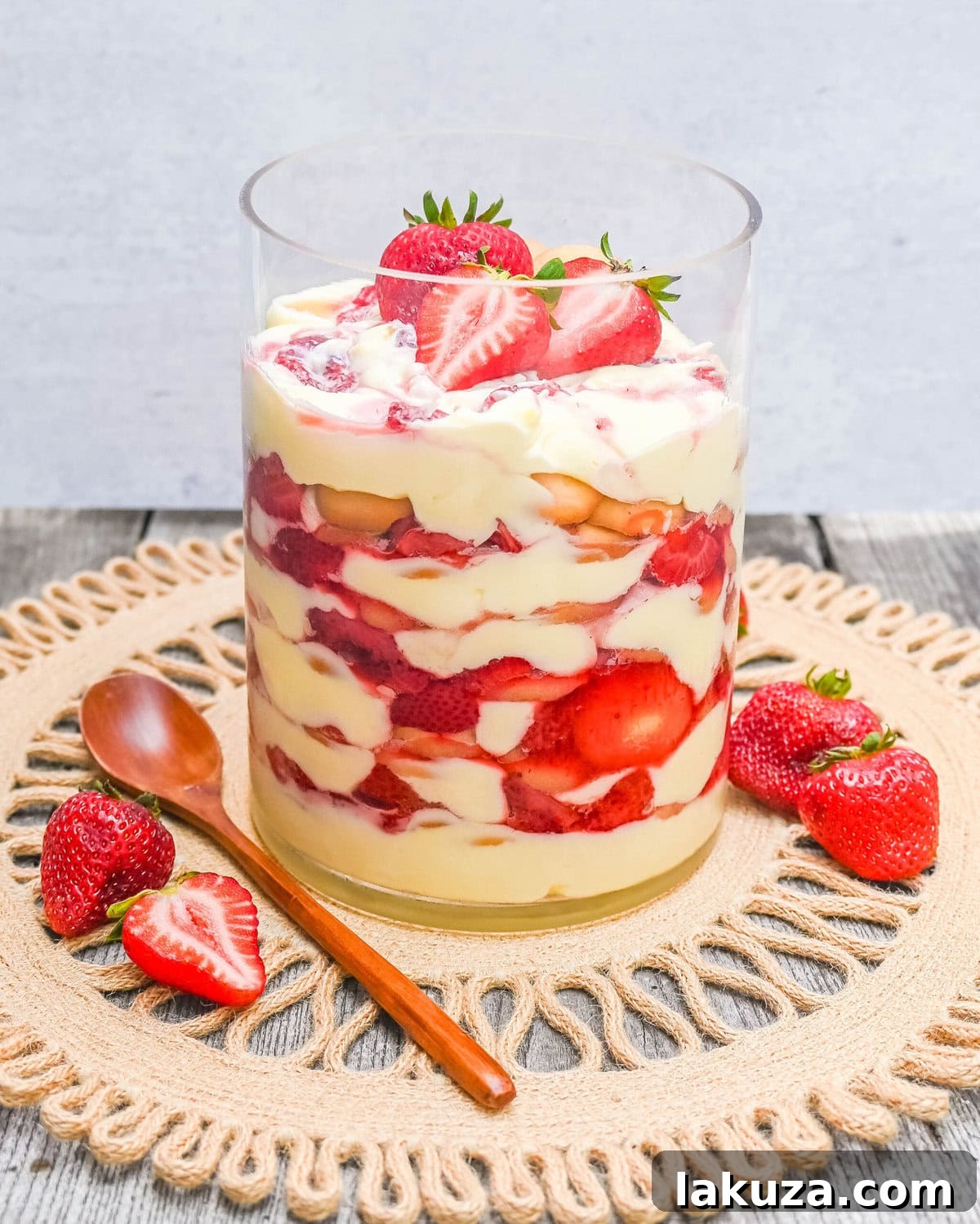 Magnolia Bakery Strawberry Shortcake Pudding layered with fresh strawberries, vanilla pudding, and Nilla wafers, ready to be chilled in a large glass bowl.