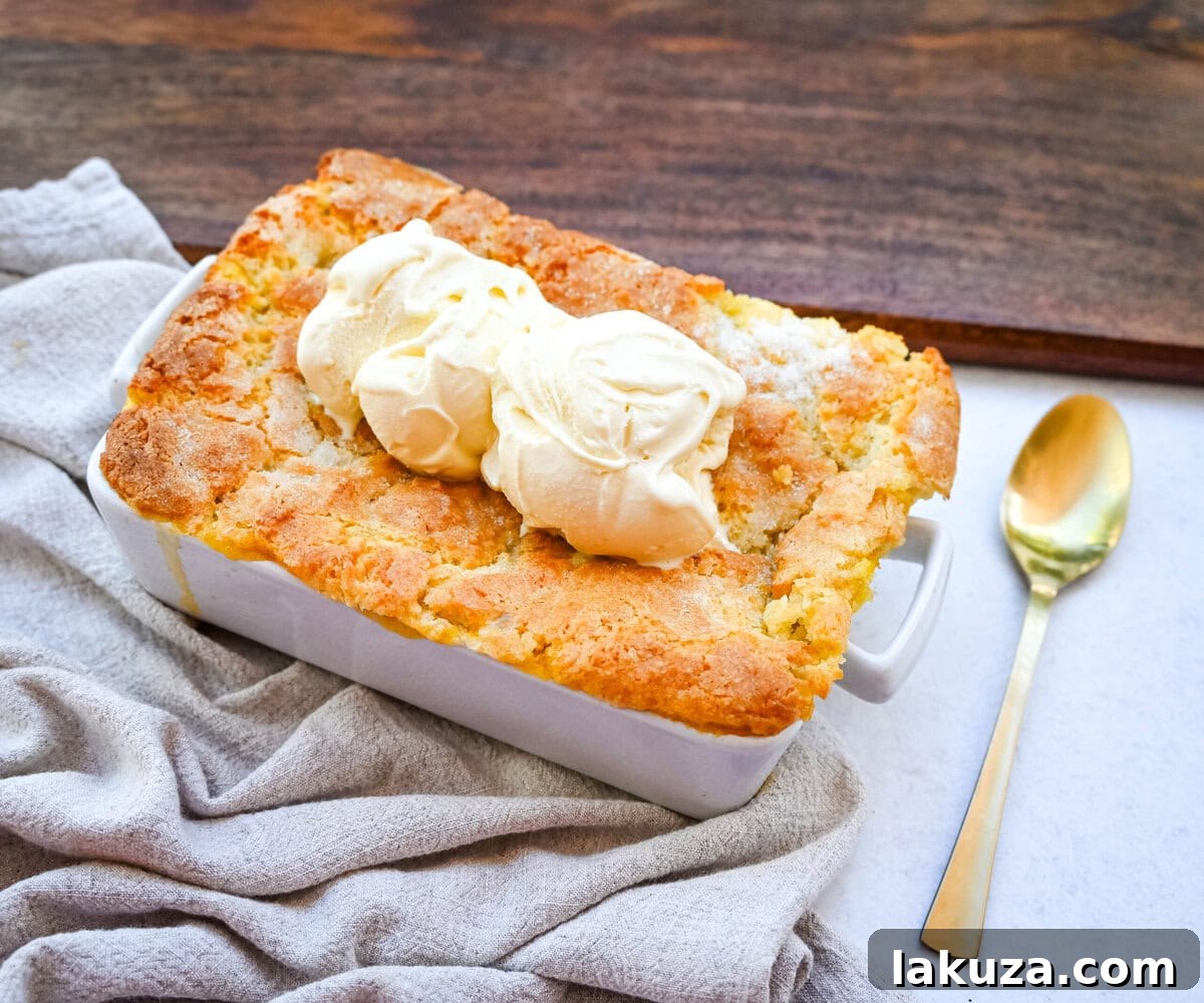 A close-up of the homemade nectarine cobbler, showcasing the tender, syrupy nectarines beneath a golden, buttery crust.
