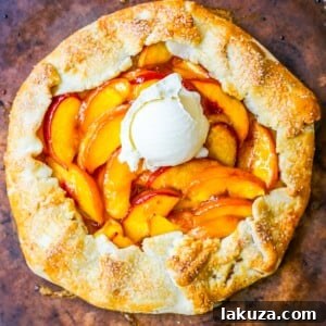 Homemade Peach Galette with a golden, flaky crust and sweet peach filling, presented on a plate.