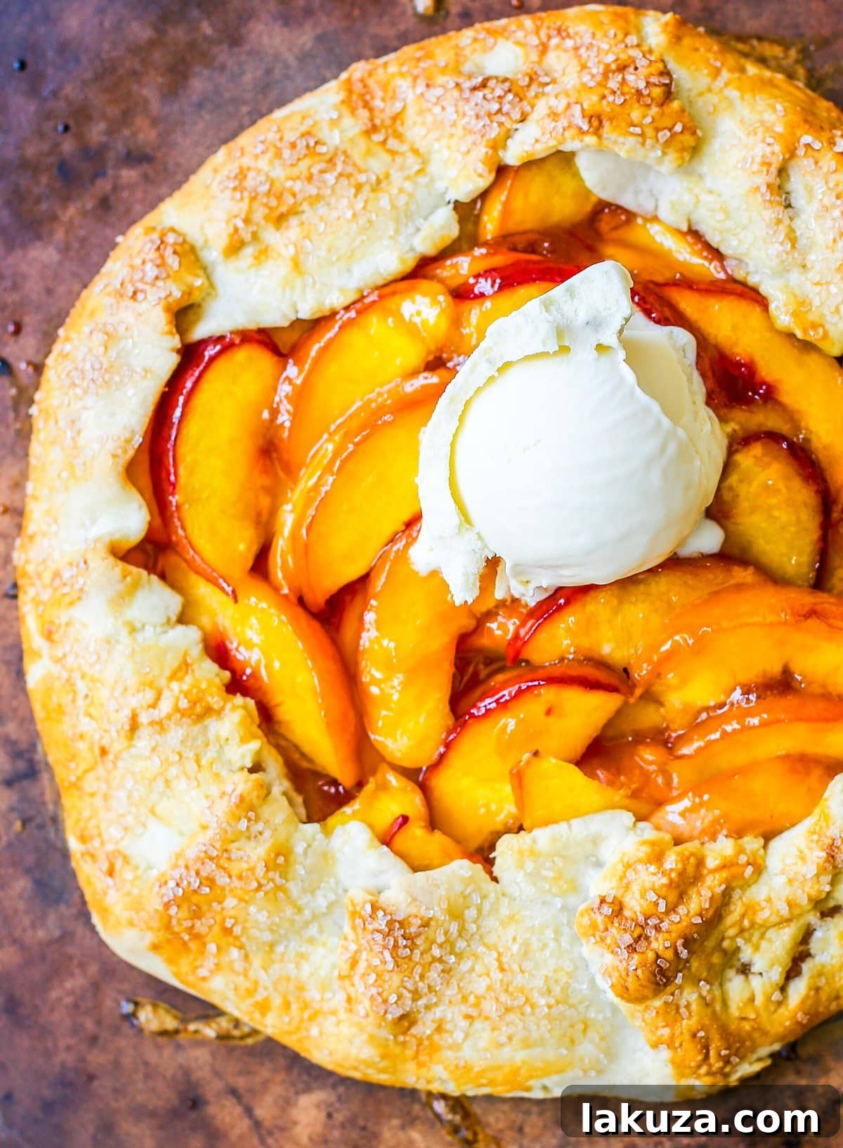 Close-up of a rustic Homemade Peach Galette, showcasing its golden, crimped edges and juicy peach filling ready to be enjoyed.