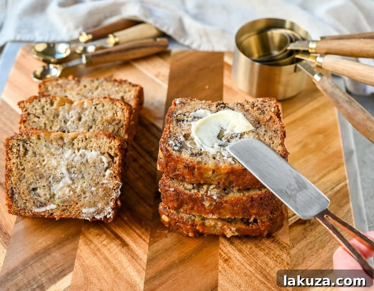 Flour Bakery Irresistible Banana Bread 8 A delectable slice of Flour Bakery Banana Bread, spread with butter, showcasing its incredible texture and irresistible appeal as the best banana nut bread.