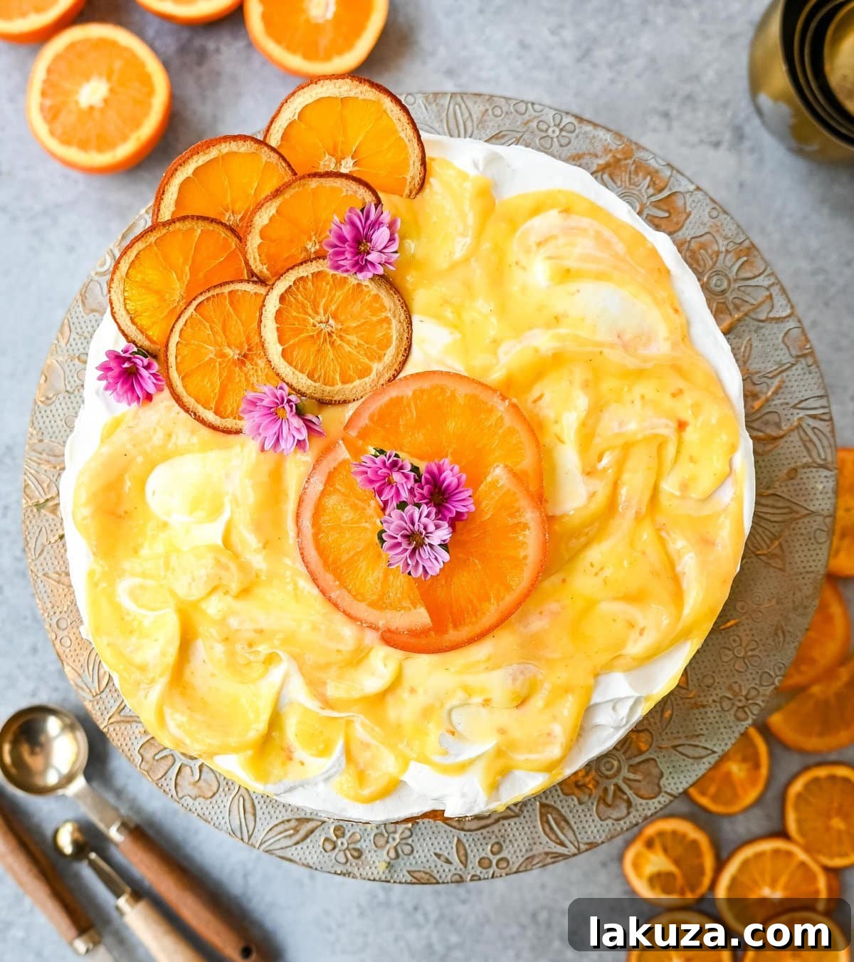 Orange Olive Oil Cake on a marble surface with fresh oranges