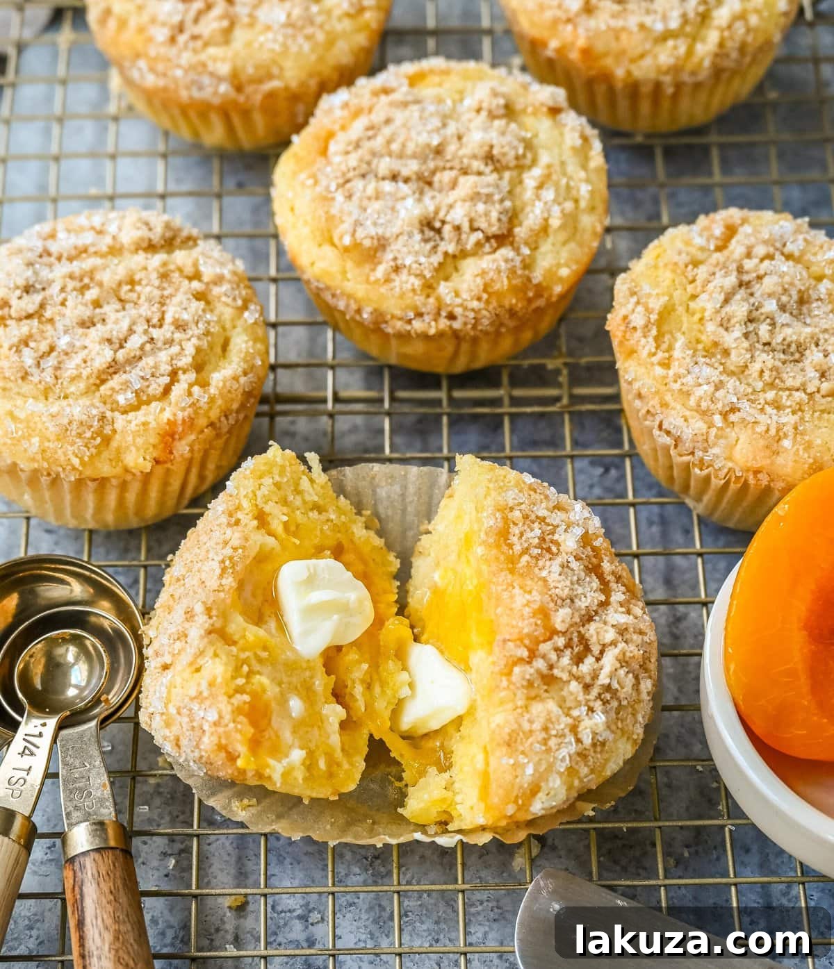 Tender, moist Peach Cobbler Muffins with fresh peaches, white chocolate chips, and a buttery streusel topping.