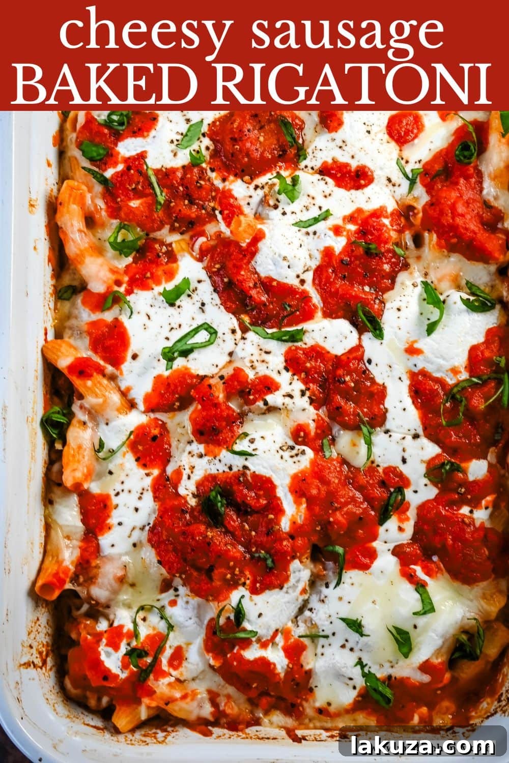 Hearty Baked Italian Sausage Rigatoni 7 Baked Rigatoni with Sausage in a white baking dish, ready to be served, with fresh basil.