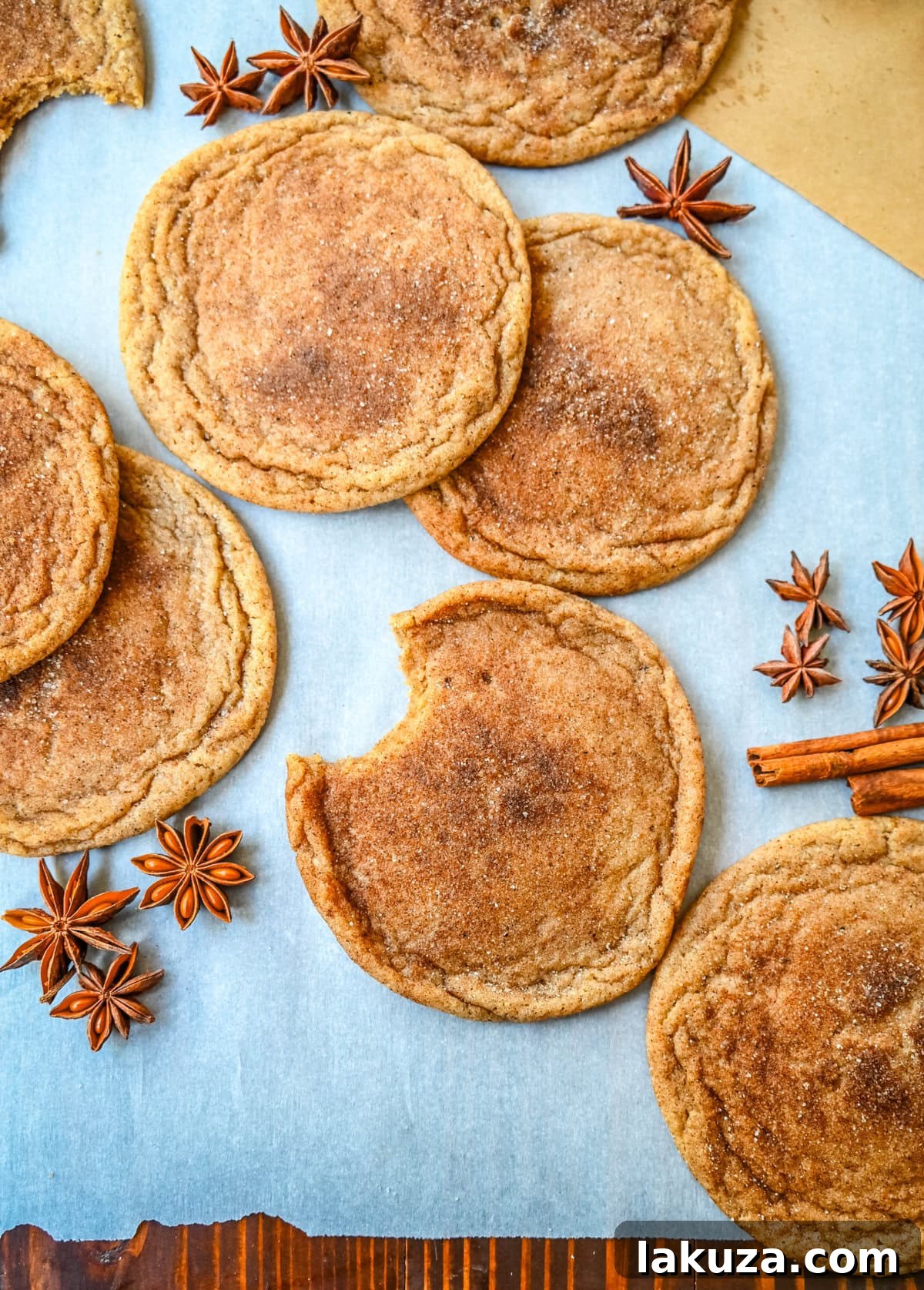 Freshly baked Chai Sugar Cookies cooling on a wire rack, showing their soft centers and spiced, crinkled exteriors.