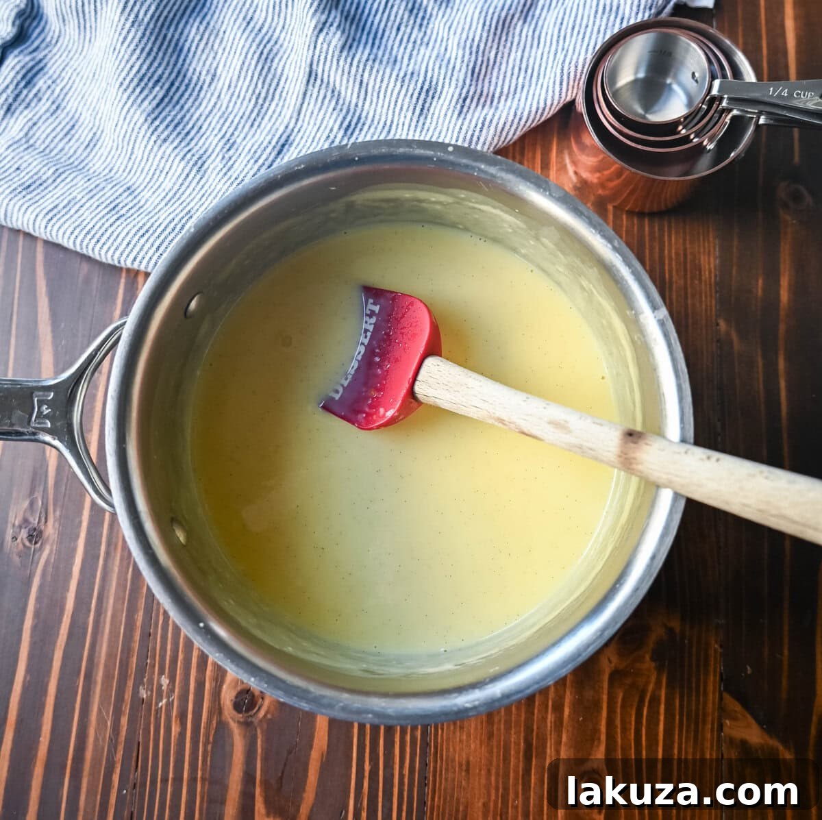 Vanilla Creme Anglaise for Bread Pudding 7 Let the vanilla sauce thicken in a saucepan after tempering the egg yolks and cream together.