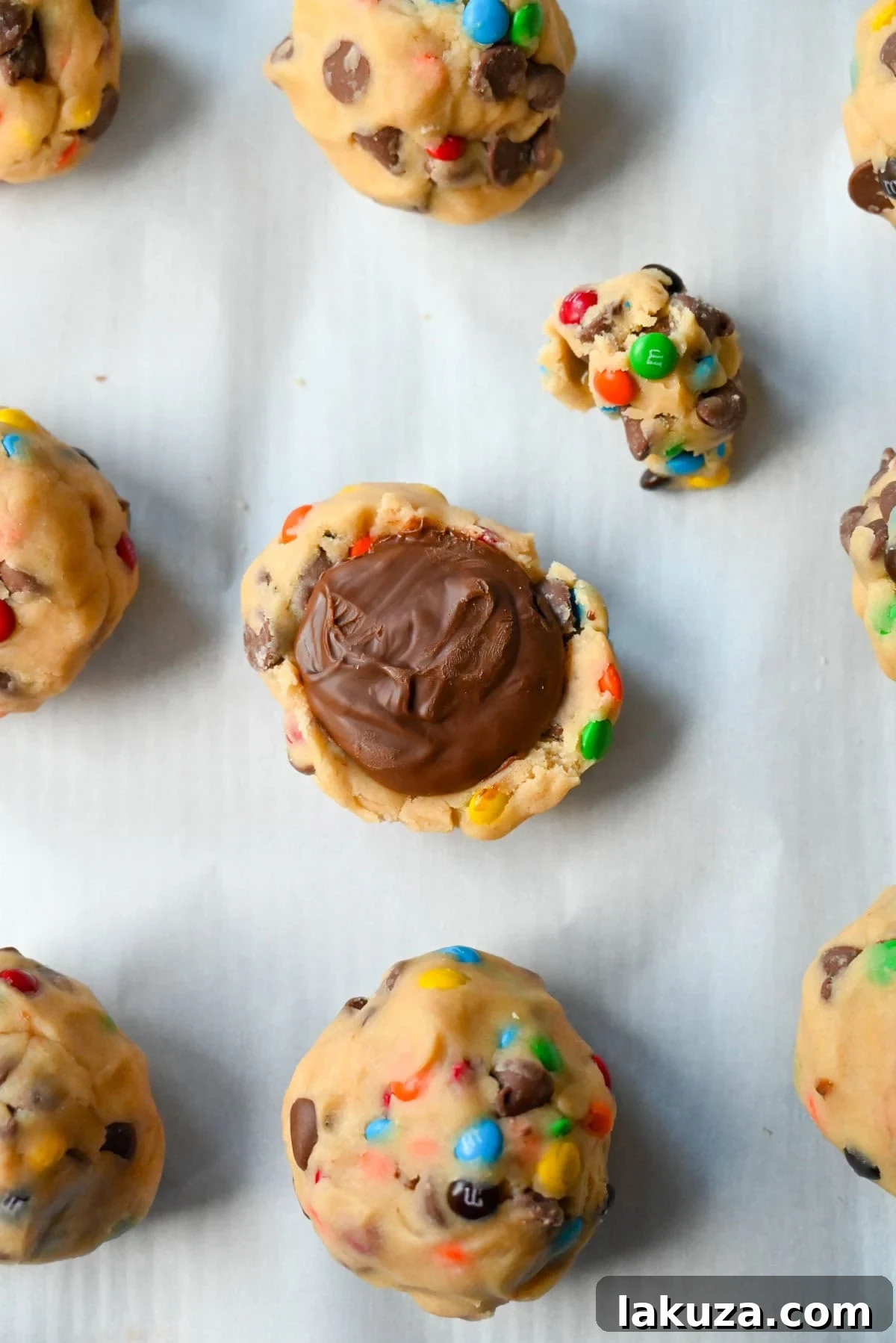 M&M Nutella Volcano Cookies 8 A M&M Nutella Lava Cookie dough ball with a frozen Nutella dollop visible before being fully sealed.