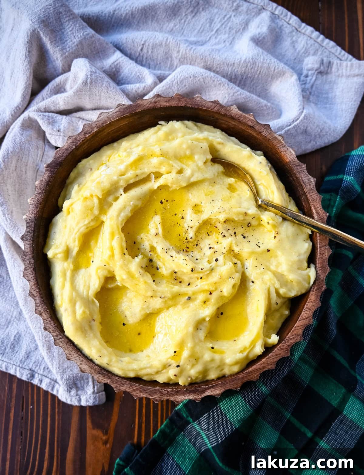 Serving bowl of luscious Browned Butter Mashed Potatoes, garnished with fresh herbs.
