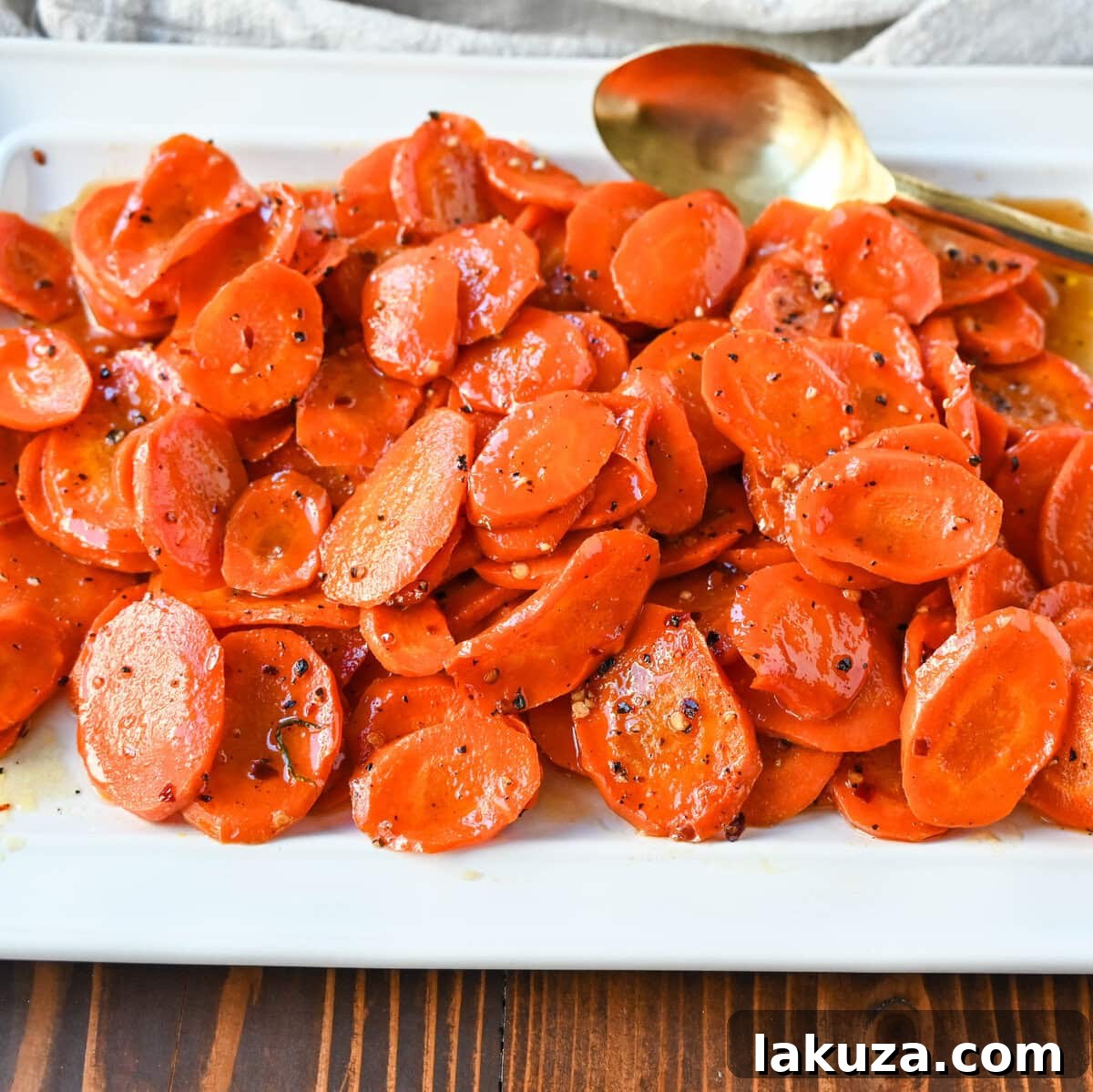 Beautifully plated Roasted Carrots with a Maple Brown Sugar Glaze, garnished with fresh herbs and optional candied pecans, ready to be served.