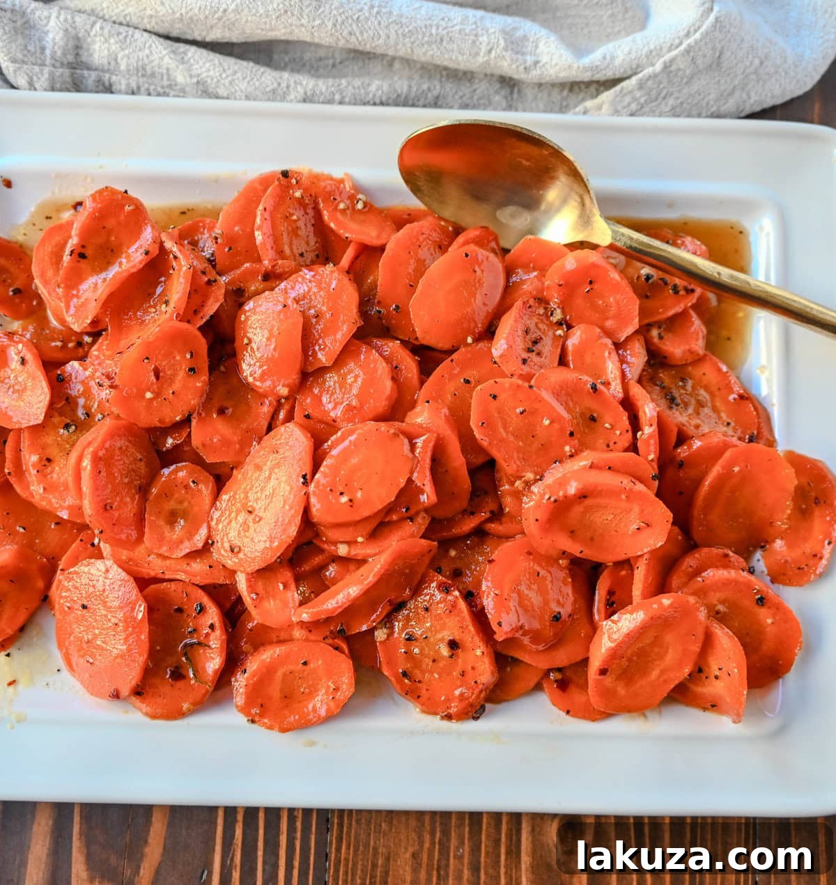 A vibrant close-up of Maple Glazed Carrots, showing their rich caramelization and a hint of red pepper flakes, ready to be enjoyed as a sweet and savory side dish.