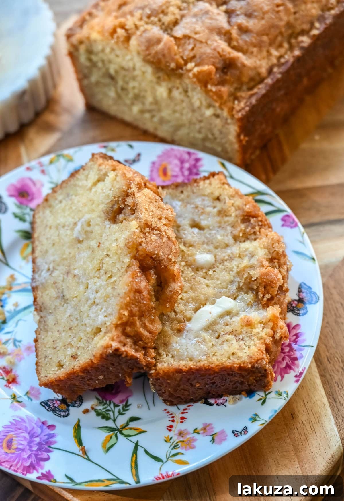 Ultimate Banana Bread Perfection 2 Perfectly baked, golden-brown banana bread loaf, sliced to reveal its moist and tender crumb.
