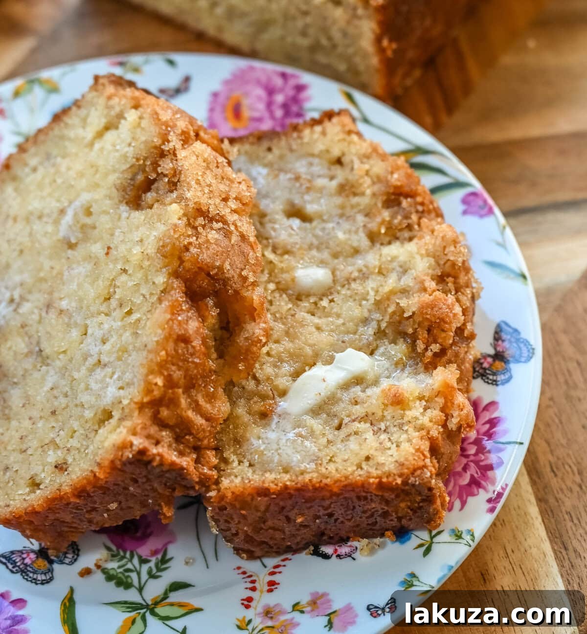 Ultimate Banana Bread Perfection 3 Close-up of the golden-brown crust of a banana bread loaf, showing a sugary topping.